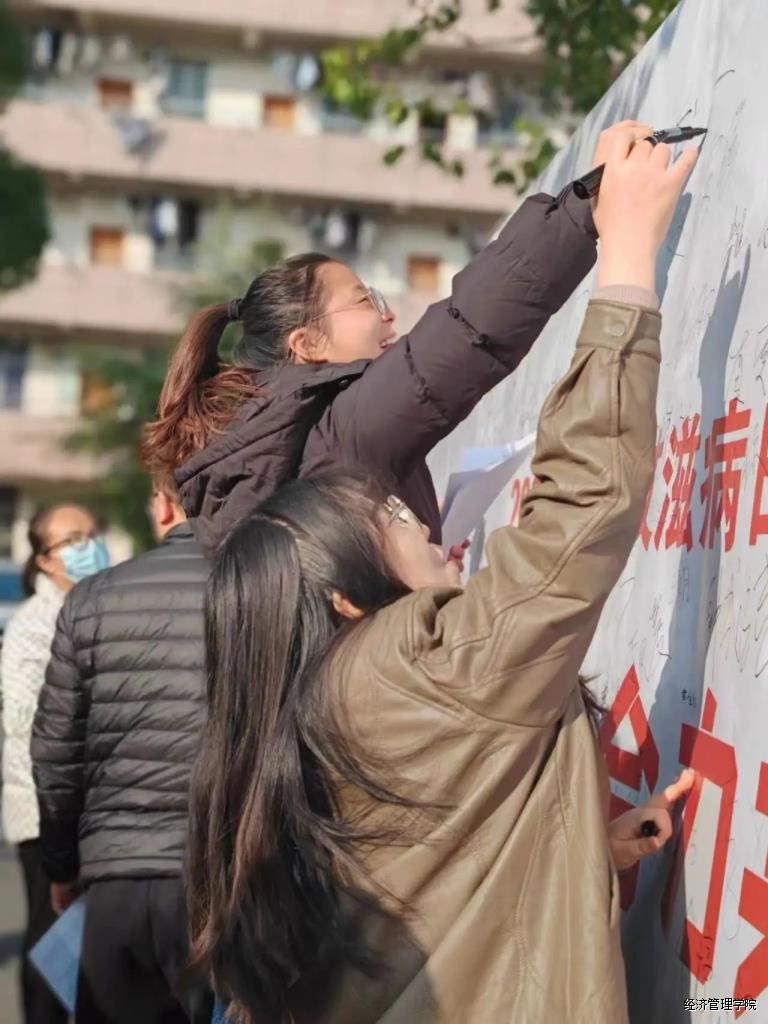 师生在“防艾”宣传板上签名